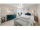 Inviting bedroom with ample light and furnishings, including a bed with decorative pillows and a bench at 5364 Dunraven Cir, Golden, CO 80403