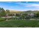 Community park with playground and pool surrounded by greenery and mountain views at 5364 Dunraven Cir, Golden, CO 80403