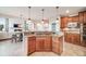 Open-concept kitchen island with gas range overlooking the living area at 5364 Dunraven Cir, Golden, CO 80403