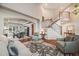 Elegant living room with hardwood floors, staircase, and an open view to the dining room at 5364 Dunraven Cir, Golden, CO 80403