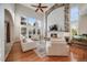 Bright living room featuring hardwood floors, a ceiling fan, and a stunning stone fireplace with a mounted television at 5364 Dunraven Cir, Golden, CO 80403