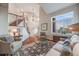 Bright living room featuring large windows, a staircase and stylish furnishings at 5364 Dunraven Cir, Golden, CO 80403