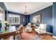 Elegant office space with dark blue walls, a chandelier, hardwood floors, and refined furnishings, perfect for work or relaxation at 5364 Dunraven Cir, Golden, CO 80403