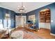 Well-appointed office space featuring built-in shelving, hardwood floors, and a charming arched doorway, ideal for productivity at 5364 Dunraven Cir, Golden, CO 80403