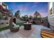 Charming patio area featuring comfortable seating, a fire pit, and lush landscaping at 5364 Dunraven Cir, Golden, CO 80403