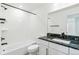 Bright bathroom featuring black hardware, a white tub, and a granite vanity at 5788 N Killarney Way, Aurora, CO 80019