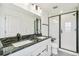 Elegant bathroom with double vanity, marble countertops, and a glass-enclosed shower at 5788 N Killarney Way, Aurora, CO 80019