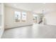 Bright living room with sleek tile flooring, large windows, and sliding door to the backyard at 5788 N Killarney Way, Aurora, CO 80019