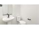 Clean and contemporary powder room with pedestal sink, modern fixtures, and a minimalist design at 5788 N Killarney Way, Aurora, CO 80019