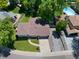 Aerial view showcasing property's layout, manicured lawn, driveway, and nearby pool and neighborhood at 6143 S Ash E Cir, Centennial, CO 80121