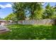Large, lush backyard with well-maintained lawn and a wooden privacy fence at 6143 S Ash E Cir, Centennial, CO 80121