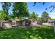 Spacious backyard featuring deck, shed, mature trees and well-maintained lawn at 6143 S Ash E Cir, Centennial, CO 80121