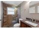 Bathroom featuring a tiled shower with a glass door and dark vanity at 6143 S Ash E Cir, Centennial, CO 80121
