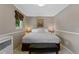 Cozy bedroom featuring a comfortable bed, bench seating, and warm lighting at 6143 S Ash E Cir, Centennial, CO 80121