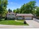 Charming two-story home with a well-manicured lawn, inviting entryway, and attached two-car garage at 6143 S Ash E Cir, Centennial, CO 80121