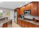 Spacious kitchen boasts stainless steel appliances, granite countertops and ample custom wood cabinetry at 6143 S Ash E Cir, Centennial, CO 80121