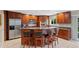 Gourmet kitchen featuring custom wood cabinetry, granite countertops, stainless steel appliances and island at 6143 S Ash E Cir, Centennial, CO 80121