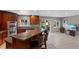 Open kitchen layout with a peninsula and seating, stainless steel appliances and view to backyard at 6143 S Ash E Cir, Centennial, CO 80121