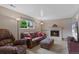 Cozy living room boasts a brick fireplace and comfortable seating with a view to the outdoors at 6143 S Ash E Cir, Centennial, CO 80121