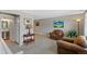Spacious living area with neutral tones, plush seating, and an adjacent bathroom at 6143 S Ash E Cir, Centennial, CO 80121