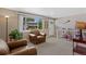 Inviting living room featuring plush armchairs, large windows, and neutral decor at 6143 S Ash E Cir, Centennial, CO 80121