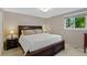 Main bedroom with a large bed, matching nightstands and window at 6143 S Ash E Cir, Centennial, CO 80121
