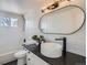 Modern bathroom boasts tub, shower, white subway tile, black fixtures, and vessel sink at 23709 Glenmoor Dr, Parker, CO 80138