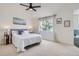 Calm bedroom featuring neutral carpet, large window, bed with stylish decor, and ample natural light at 23709 Glenmoor Dr, Parker, CO 80138