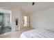 Neutral bedroom showcasing a full bath, open doorway, plush carpet and minimalist design at 23709 Glenmoor Dr, Parker, CO 80138