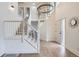 Bright entryway with a grand staircase, wood flooring, and elegant chandelier at 23709 Glenmoor Dr, Parker, CO 80138