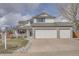 Inviting two-story home featuring a three-car garage, manicured lawn, and charming front porch at 23709 Glenmoor Dr, Parker, CO 80138