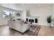 Bright living room features fireplace with shiplap accent wall, window, neutral decor, and wood flooring at 23709 Glenmoor Dr, Parker, CO 80138