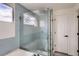 Modern shower with tile walls, glass enclosure, built-in seat and shelves, and a window at 23709 Glenmoor Dr, Parker, CO 80138