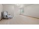 Spacious basement featuring neutral carpet, ample lighting, and a comfortable chair, creating a versatile living space at 22312 E Plymouth Cir, Aurora, CO 80016