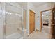 Shower with glass door, tiled walls, and built-in bench, providing a luxurious bathing experience at 22312 E Plymouth Cir, Aurora, CO 80016