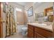 Bathroom featuring tiled shower, vanity with storage, and neutral color scheme at 22312 E Plymouth Cir, Aurora, CO 80016