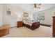 Cozy bedroom featuring a ceiling fan, wrought iron bed frame, and carpet flooring, perfect for relaxation at 22312 E Plymouth Cir, Aurora, CO 80016