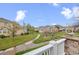 Landscaped community with homes, walking path, green lawns, flowering trees, and stone entrance at 22312 E Plymouth Cir, Aurora, CO 80016