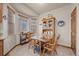 Cozy eat-in kitchen with wooden table, cabinetry and sun-lit windows at 22312 E Plymouth Cir, Aurora, CO 80016