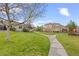 Beautifully maintained homes surrounded by lush green lawns and a walking path add to the community's appeal at 22312 E Plymouth Cir, Aurora, CO 80016