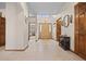 Bright foyer featuring tile flooring, wood accents, and a clear view to other rooms at 22312 E Plymouth Cir, Aurora, CO 80016
