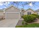 Inviting home with a two-car garage, stone accents, and a well-maintained front yard at 22312 E Plymouth Cir, Aurora, CO 80016