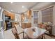 Bright kitchen with stainless steel appliances, wooden cabinets, granite counters, and a dining area at 22312 E Plymouth Cir, Aurora, CO 80016