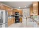 Well-lit kitchen features stainless steel appliances and granite countertops at 22312 E Plymouth Cir, Aurora, CO 80016