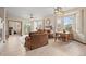 Open-concept living room with fireplace, large windows, and comfortable seating at 22312 E Plymouth Cir, Aurora, CO 80016