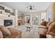 Cozy living room with fireplace, ceiling fan and sliding glass door to outdoor patio at 22312 E Plymouth Cir, Aurora, CO 80016