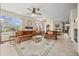 Inviting living room with a large window, a ceiling fan, and a vintage carpet and furniture at 22312 E Plymouth Cir, Aurora, CO 80016
