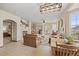 Spacious living room with fireplace, built-in shelving, natural light, and adjoining living spaces at 22312 E Plymouth Cir, Aurora, CO 80016