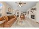 Cozy living room with natural light, fireplace and eat-in kitchen with view to the dining room at 22312 E Plymouth Cir, Aurora, CO 80016