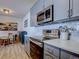 Modern kitchen with stainless steel appliances and gray cabinets at 14221 E 1St Dr # 304, Aurora, CO 80011